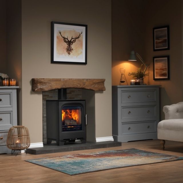 Living room with a fireplace, gray cabinets, and decorative elements.
