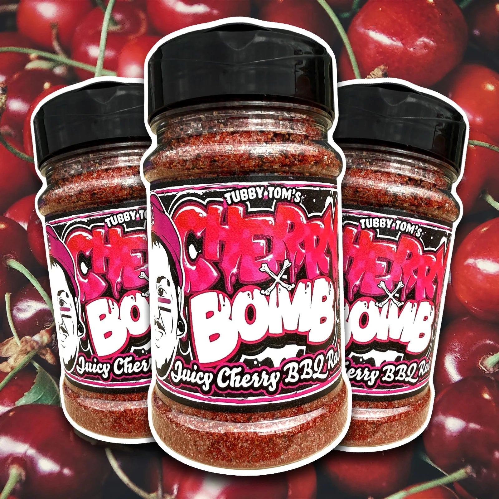 Three jars of Tubby Tom's Cherry Bomb BBQ Rub on a background of cherries.