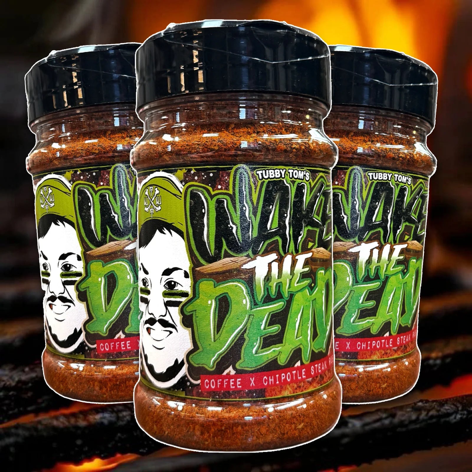 Three jars of 'Tubby Tom's Wake The Dead' spice blend on a fiery background
