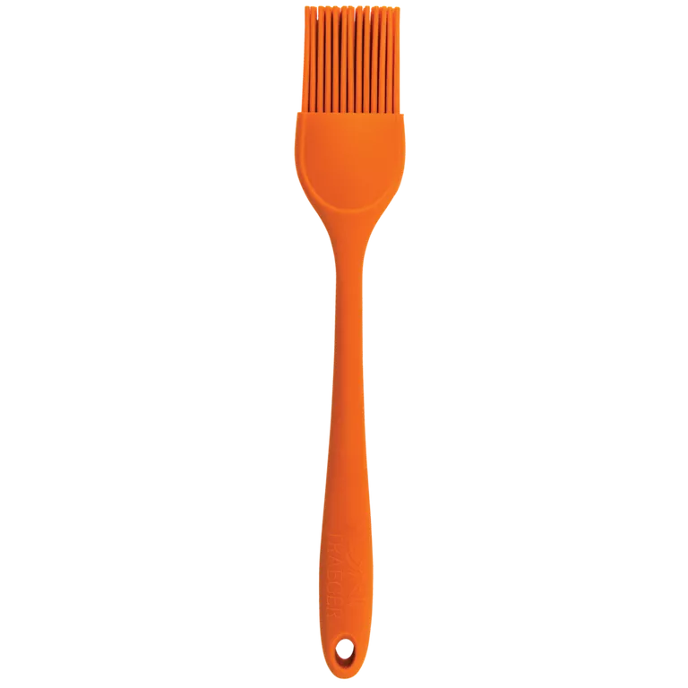 Orange Traeger silicone brush on a white background