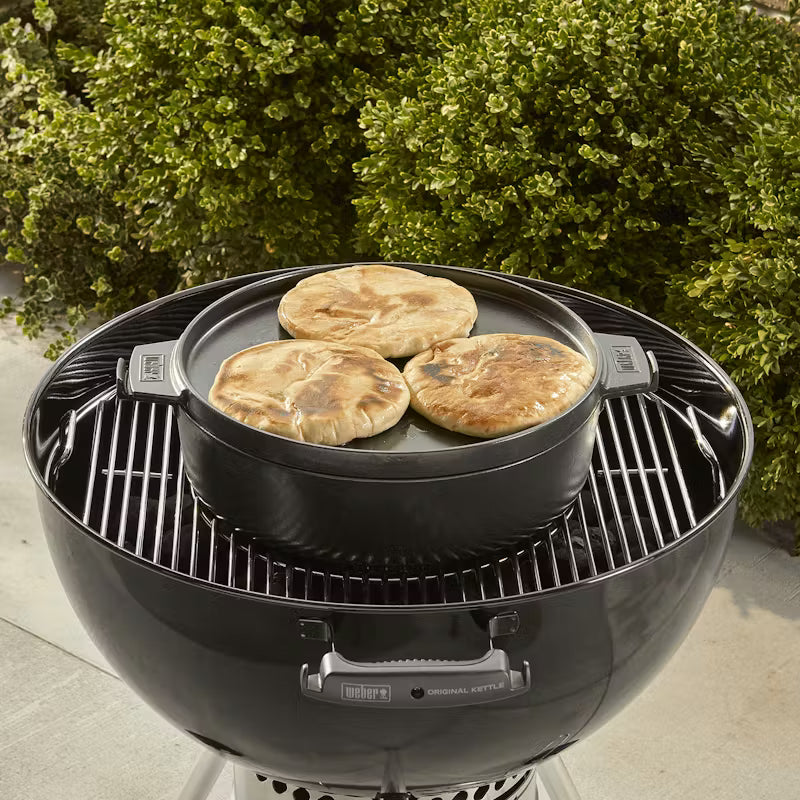 Weber Dutch Oven Duo being used to warm flatbreads inside a Weber Master Touch grill