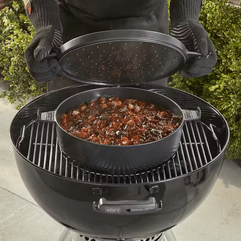 Weber Dutch Oven Duo Insert with slow cooked food inside of a Weber Master Touch BBQ