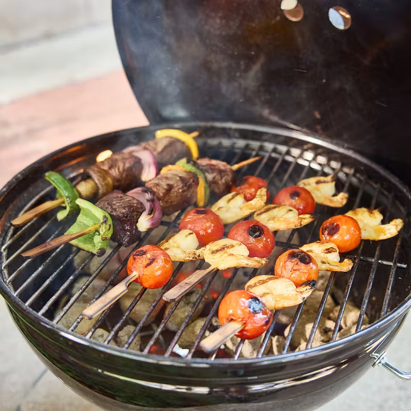 Weber Smokey Joe Charcoal Barbecue 37cm Black with skewers of vegetables and meat cooking on a grill