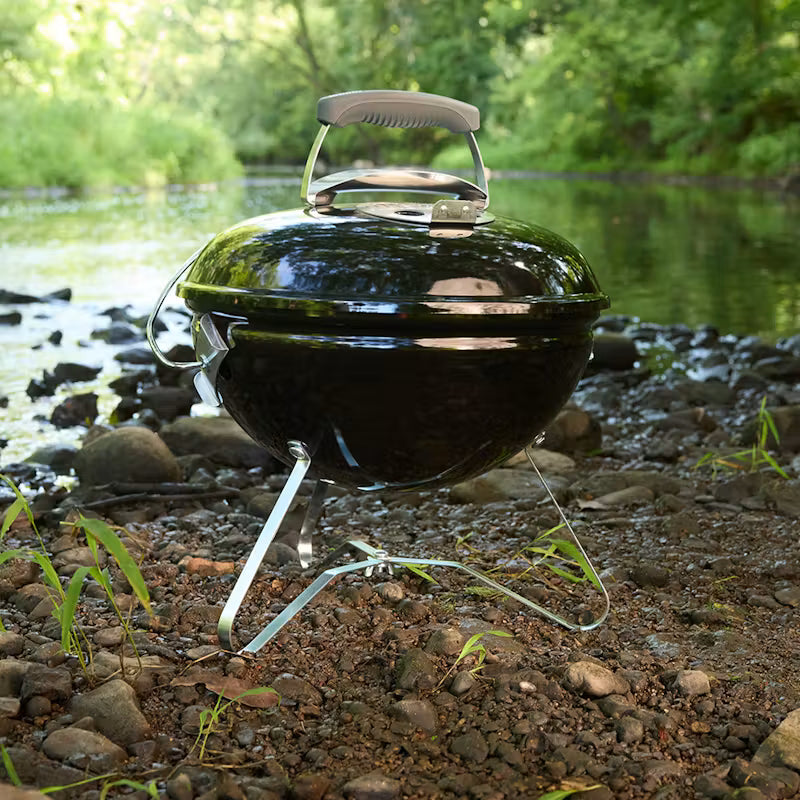 Weber Smokey Joe Charcoal Barbecue 37cm Black near a body of water with greenery