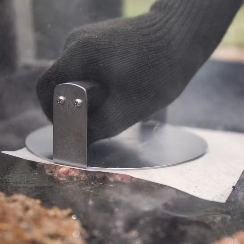 Weber Stainless Steel Burger Press being used to smash a burger patty